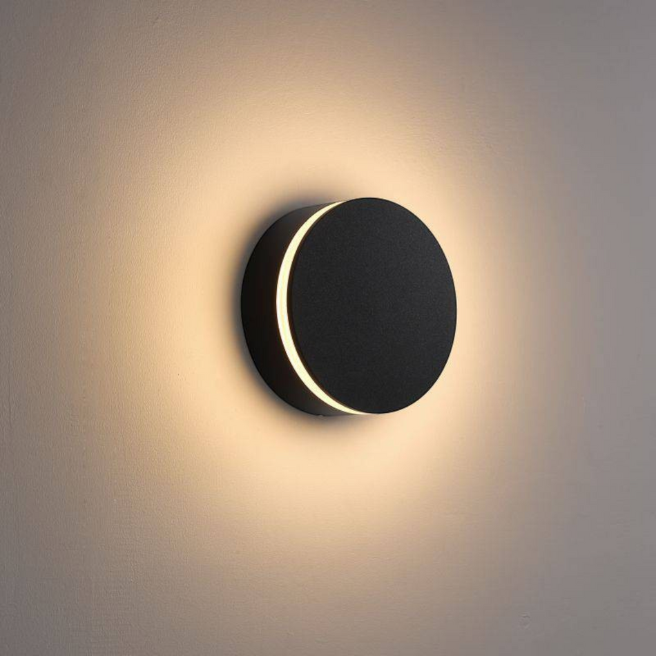 Ultra Beam Lighting Ltd round black LED outdoor wall lamp with a warm halo glow and opal acrylic diffuser