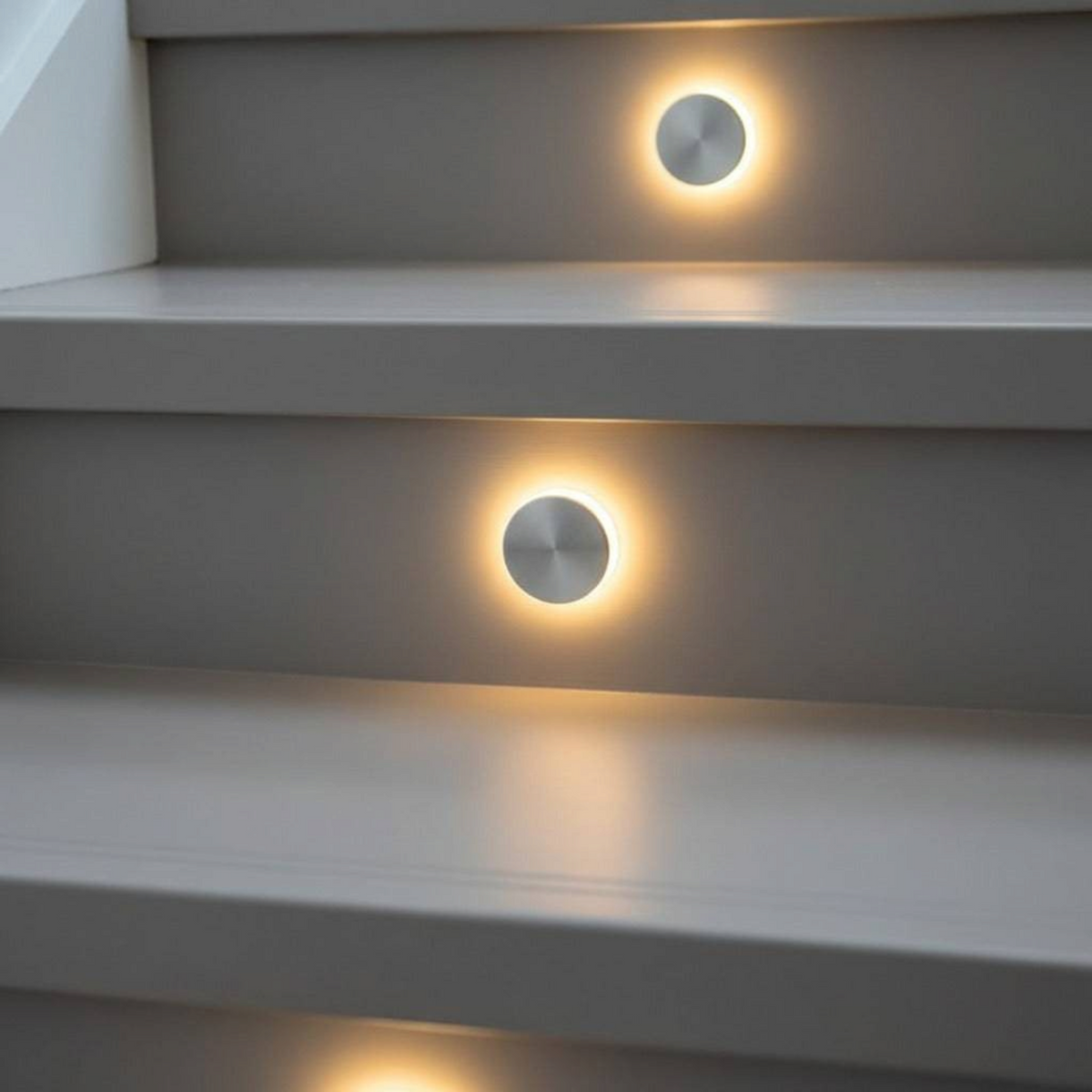 Ultra Beam Lighting Ltd round 1 watt recessed LED staircase tread light with polished aluminium faceplate and halo glow