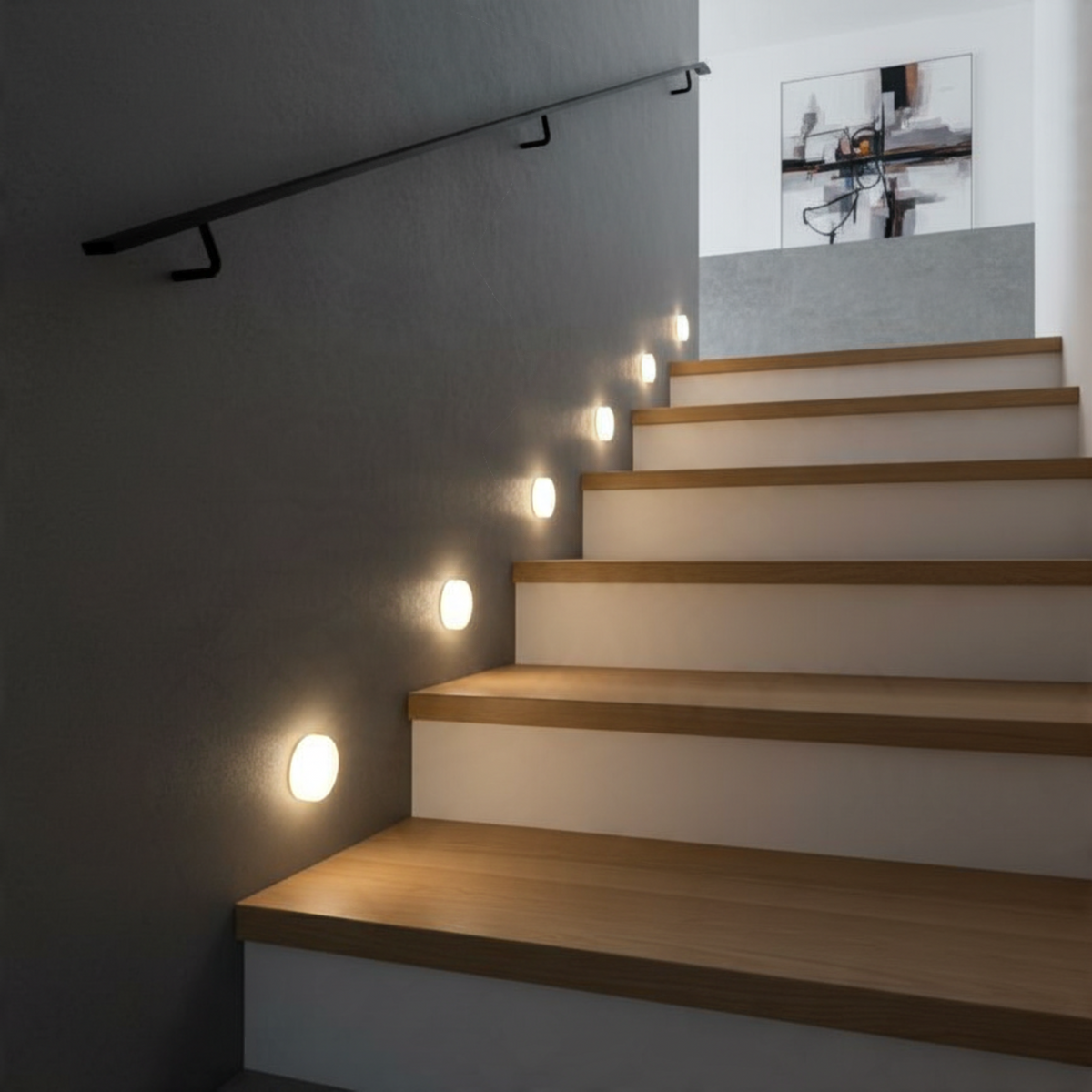 Ultra Beam Lighting Ltd round 1 watt LED recessed stair tread lights with soft acrylic diffusers on a dark wall.