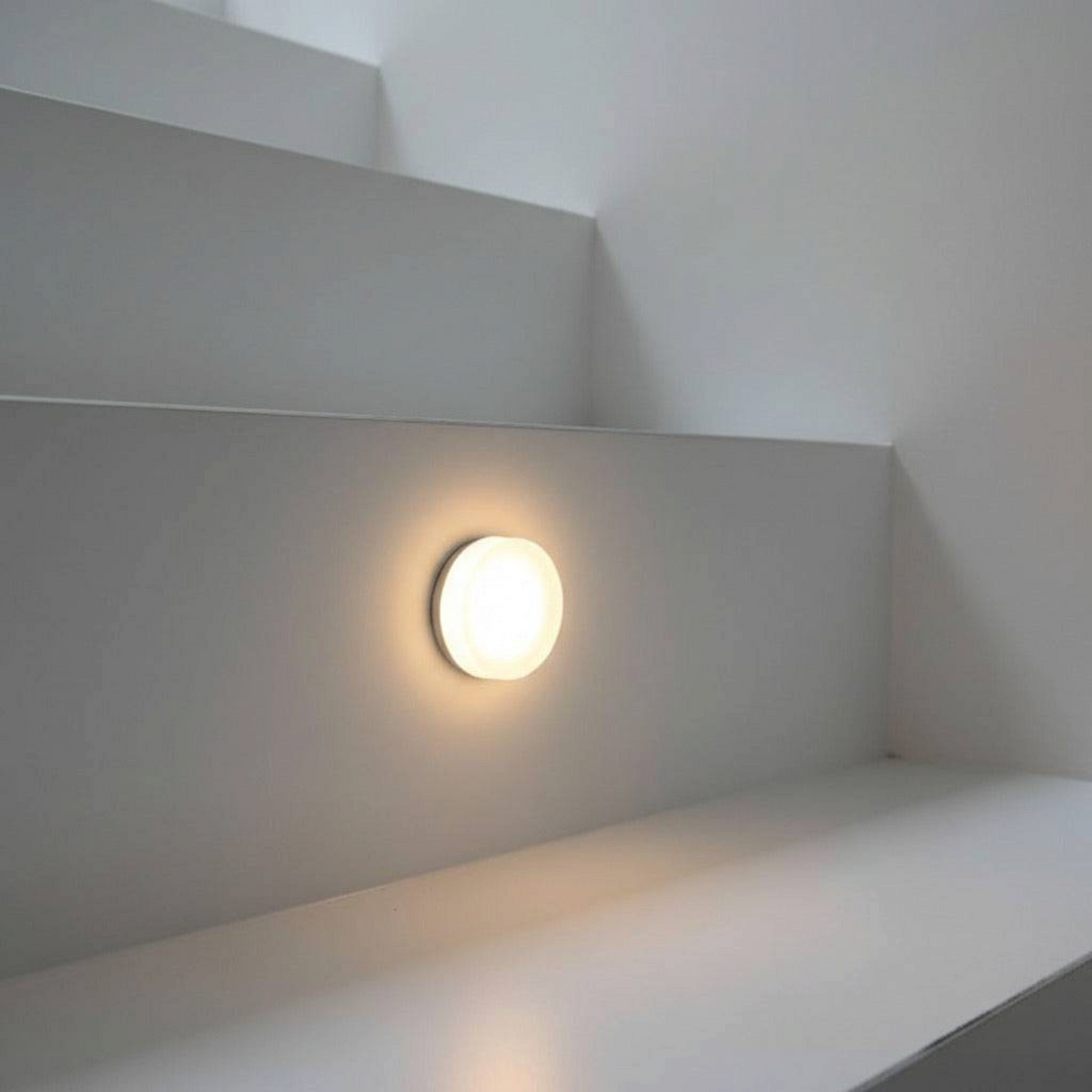 Ultra Beam Lighting Ltd round 1 watt LED recessed stair light with sand-blasted acrylic diffuser on white wall