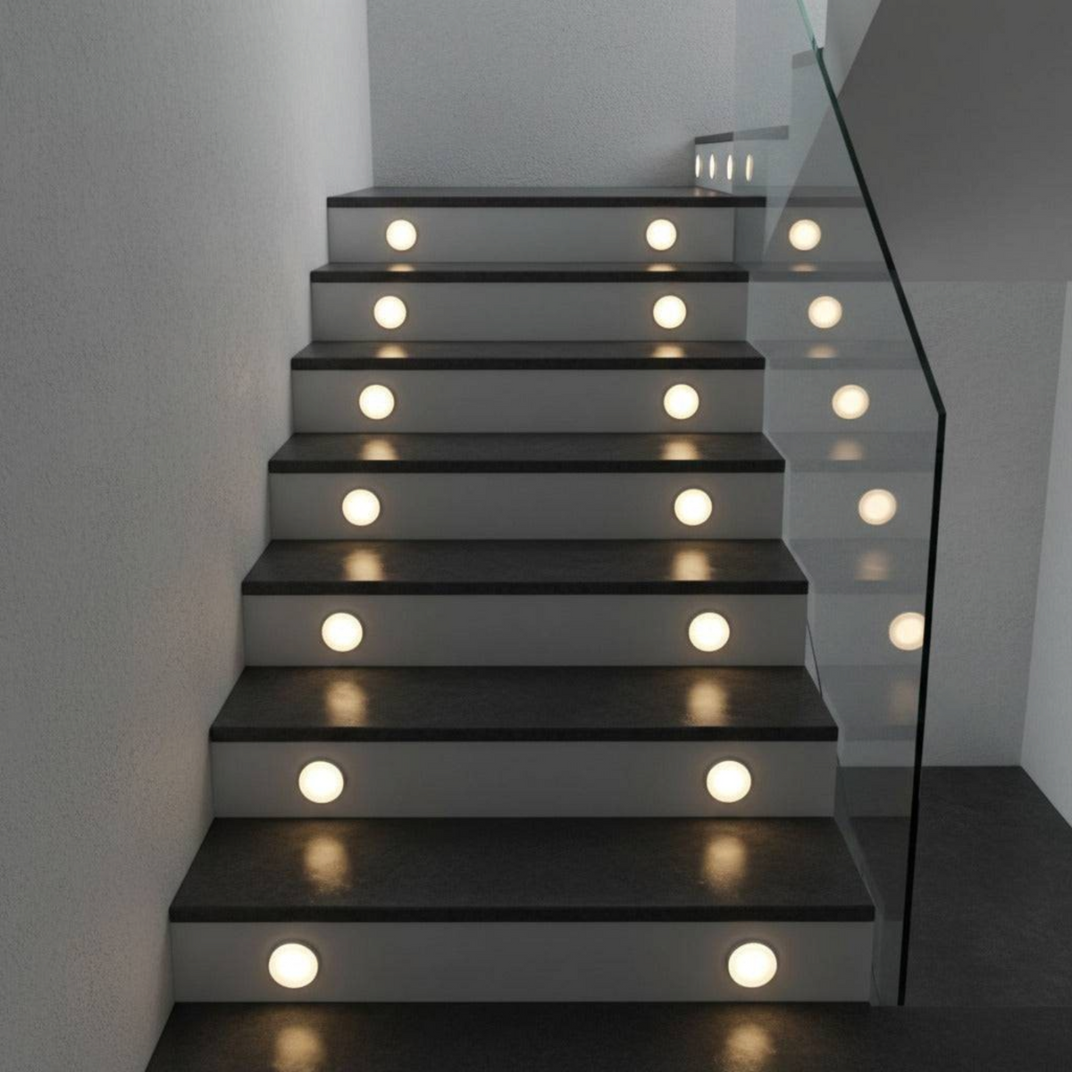 Ultra Beam Lighting Ltd round 1 watt recessed LED stair tread lights with soft acrylic diffusers on dark stairs