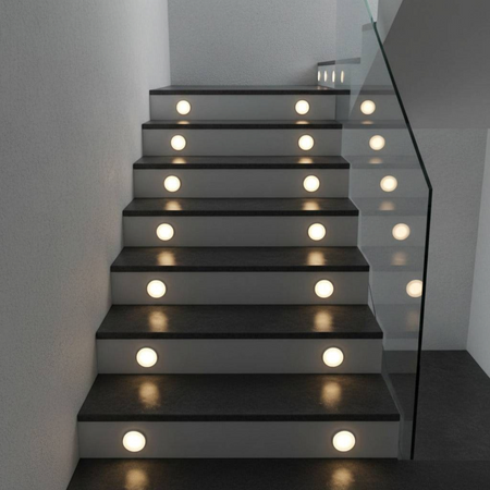 Ultra Beam Lighting Ltd round 1 watt recessed LED stair tread lights with soft acrylic diffusers on dark stairs