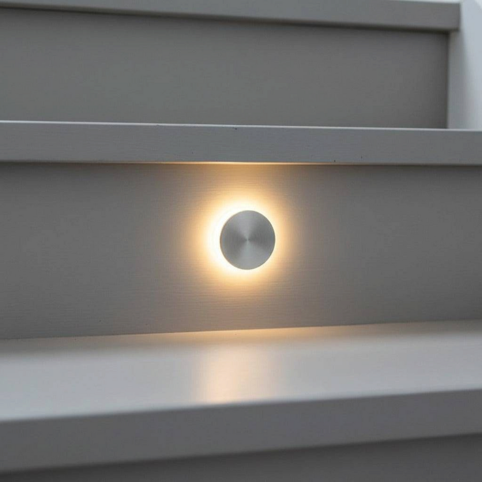 Ultra Beam Lighting Ltd round recessed LED staircase tread light with a polished aluminium finish and halo glow