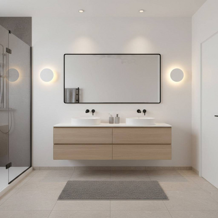 white modern bathroom wall sconce mounted either side of a mirror in a modern bathroom