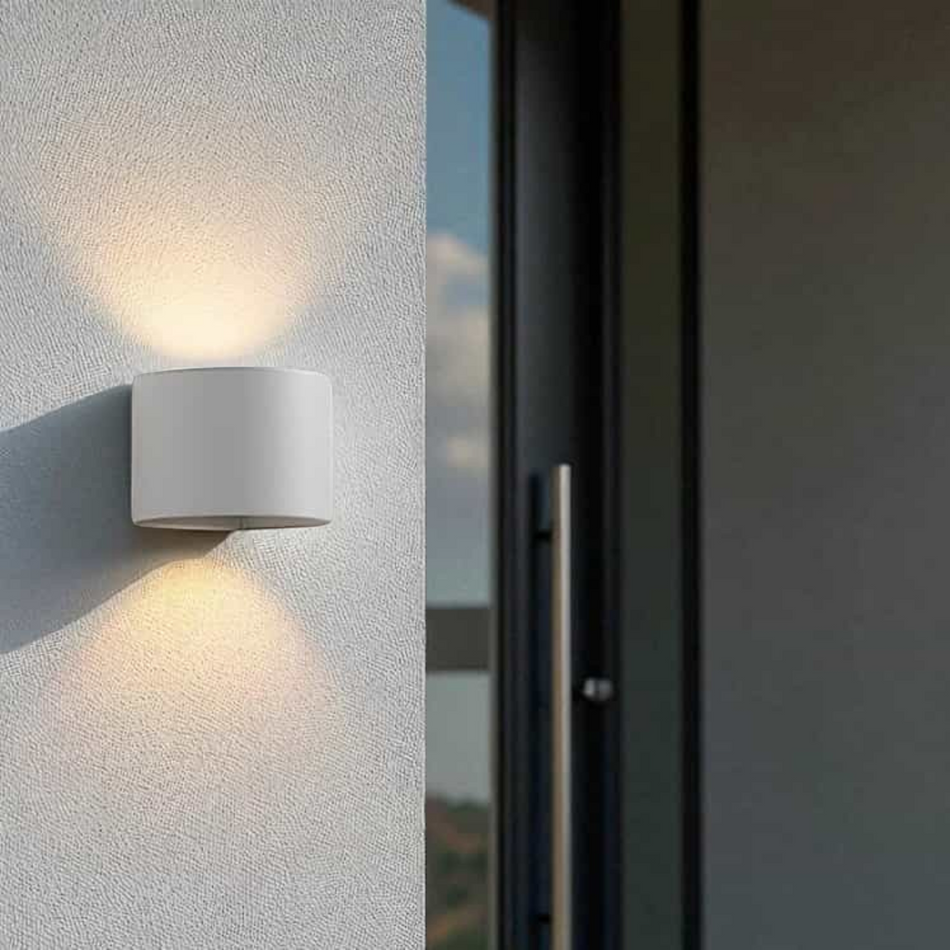 white outdoor up and down light mounted on a white exterior wall next to the front door of a house