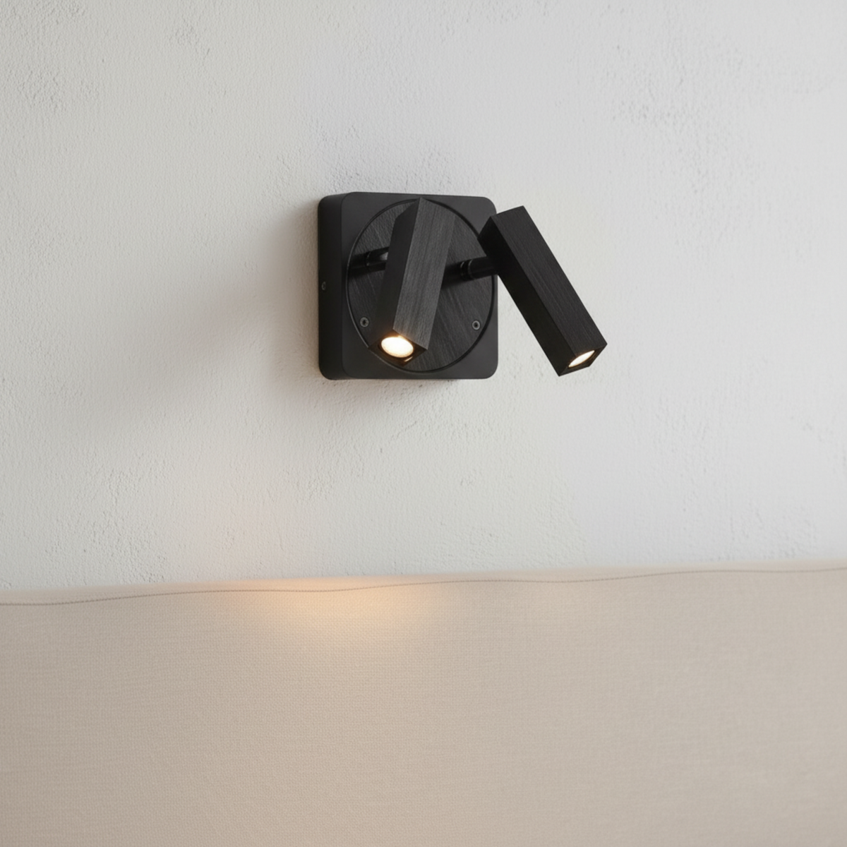 Ultra Beam Lighting Ltd Seville twin 3 watt black LED reading lamp with adjustable heads mounted on a white wall.