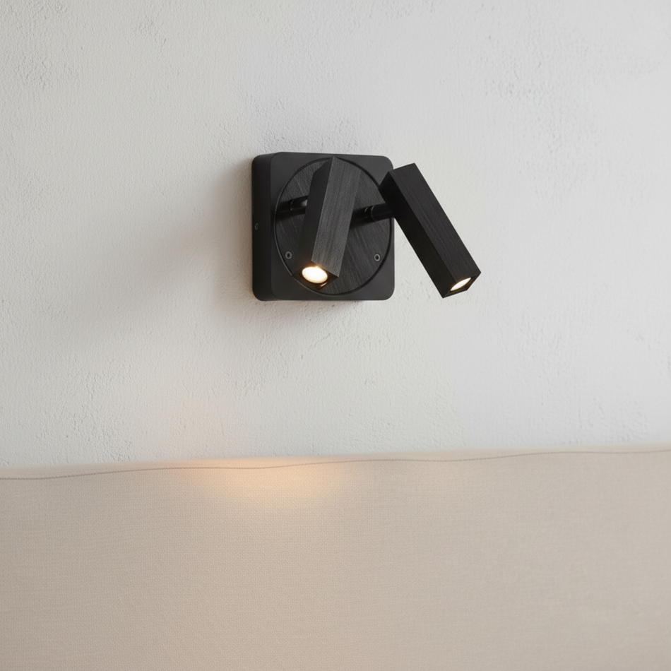 Ultra Beam Lighting Ltd Seville twin 3 watt black LED reading lamp with adjustable heads mounted on a white wall.