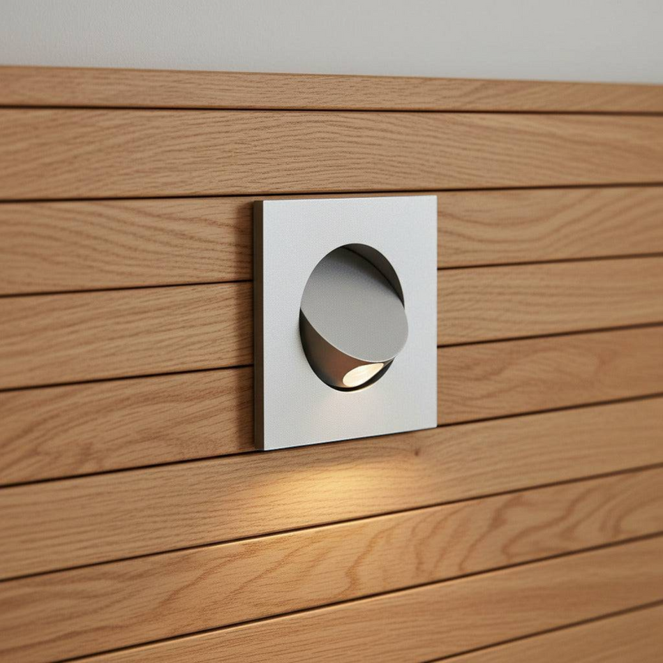 Ultra Beam Lighting Ltd square silver recessed LED reading lamp mounted flush on a wooden headboard