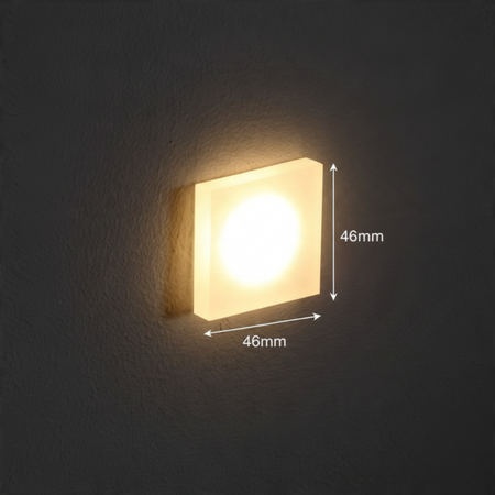 Ultra Beam Lighting Ltd square 1 watt LED recessed stair light with a sandblasted acrylic face emitting warm light.