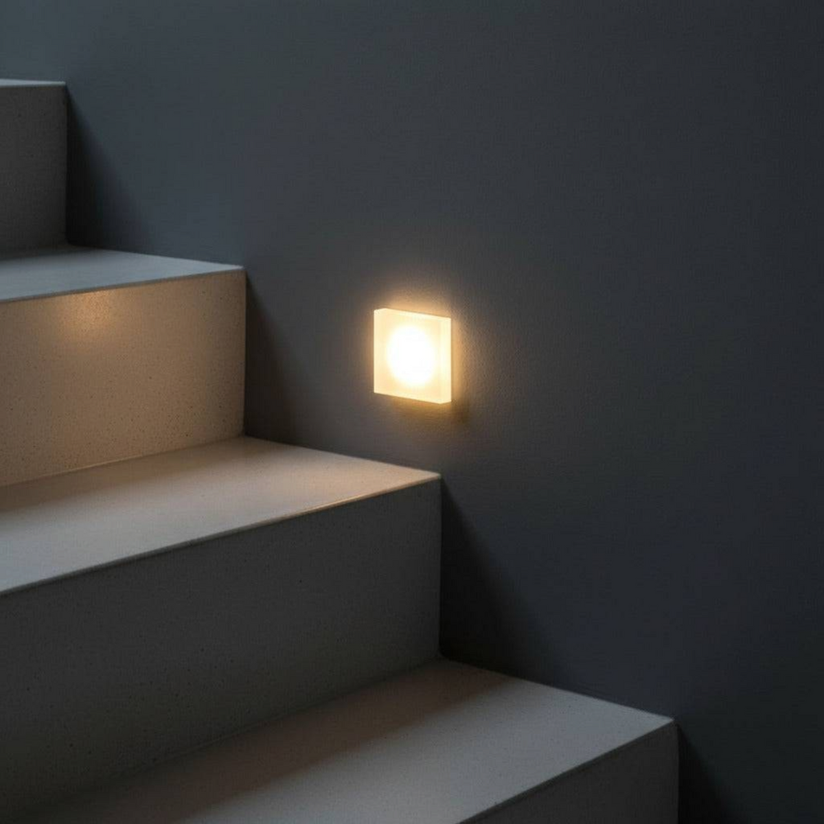 Ultra Beam Lighting Ltd square 1 watt LED recessed stair light with a sandblasted acrylic face emitting warm light.