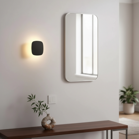 Ultra Beam Lighting Ltd 6W square black LED vanity wall light with warm halo glow mounted in a modern hallway