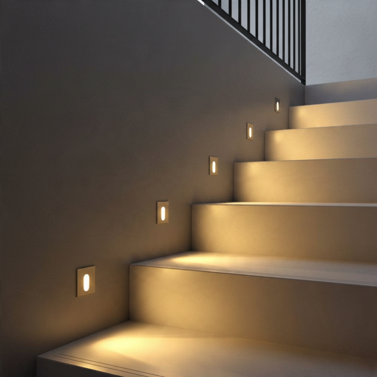 Ultra Beam Lighting Ltd square recessed LED wall light with brushed aluminum finish illuminating a modern staircase