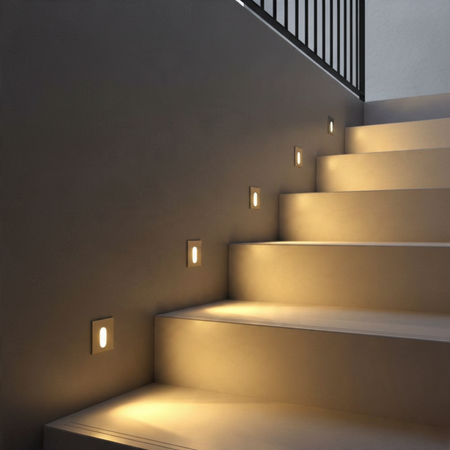 Ultra Beam Lighting Ltd square recessed LED wall light with brushed aluminum finish illuminating a modern staircase