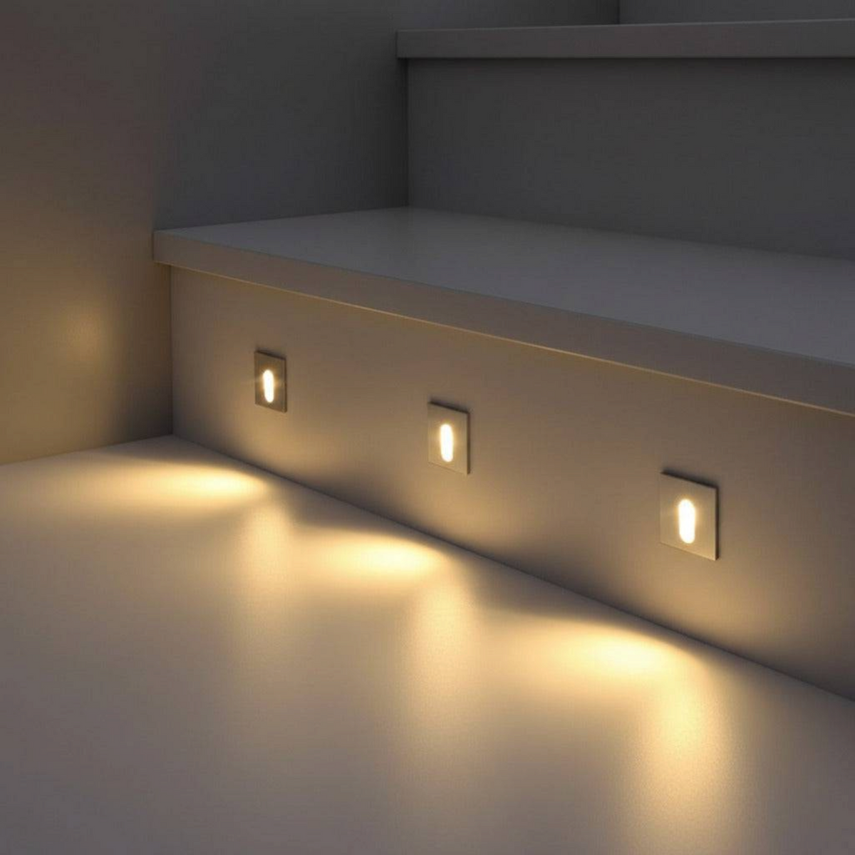 Ultra Beam Lighting Ltd square recessed LED stair lights with brushed aluminum finish illuminating a staircase