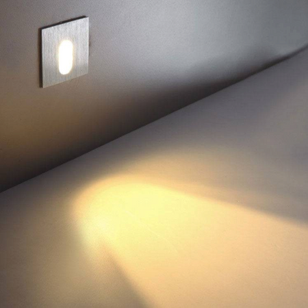 Ultra Beam Lighting Ltd square recessed LED wall light with brushed aluminum finish casting a warm downward beam