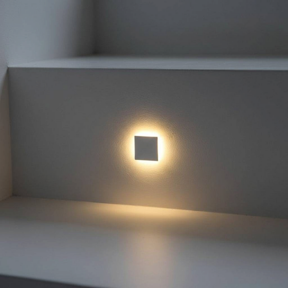 Ultra Beam Lighting Ltd square recessed LED step light with polished aluminium faceplate installed on a white stair