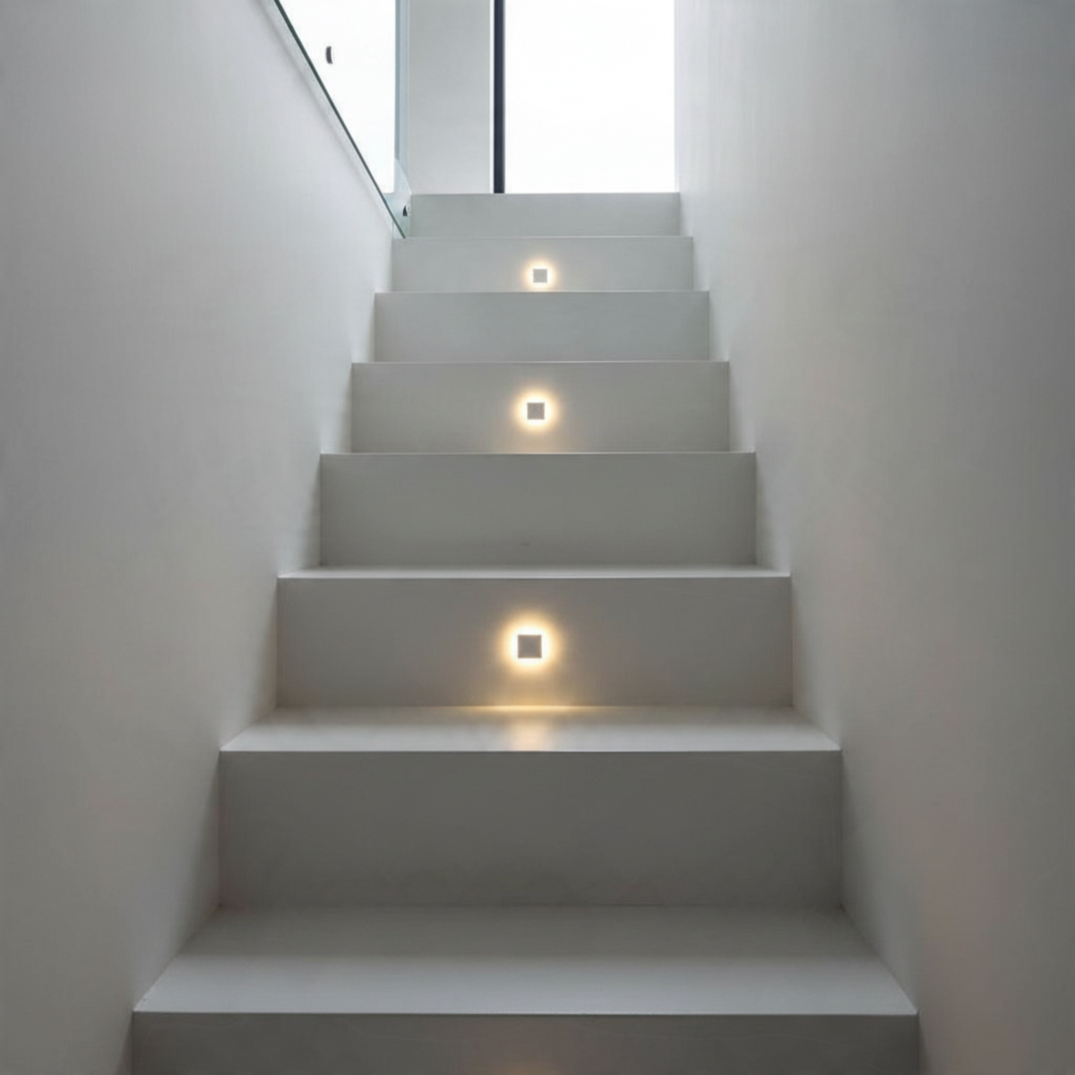 Ultra Beam Lighting Ltd square recessed LED step lights installed on a modern white staircase for ambient illumination
