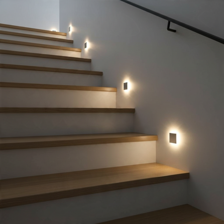 Ultra Beam Lighting Ltd square recessed LED step light installed on a modern staircase wall with warm ambient glow