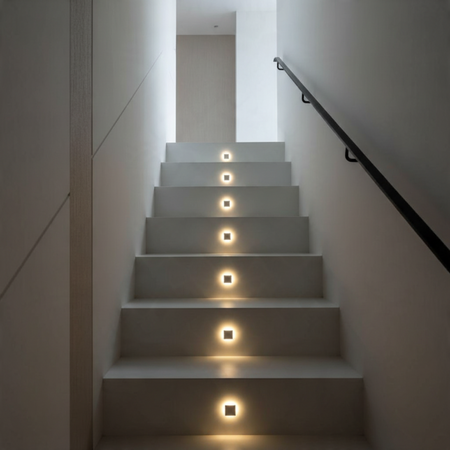 Ultra Beam Lighting Ltd square recessed LED step lights installed in a modern staircase for ambient illumination