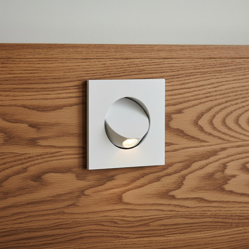 Ultra Beam Lighting Ltd square white recessed LED reading light tilted open on a wooden headboard