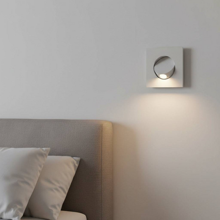 Ultra Beam Lighting Ltd square white recessed LED reading light installed in a bedroom wall above a grey headboard
