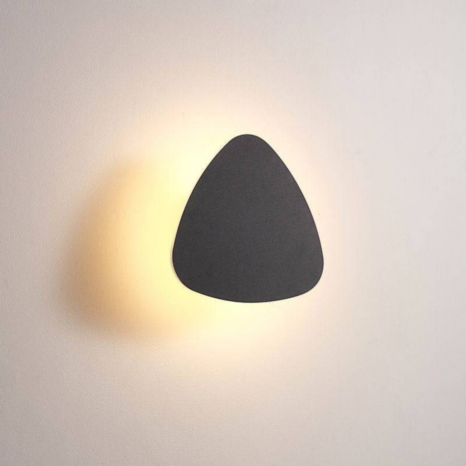 Ultra Beam Lighting Ltd triangular black LED bathroom sconce with a soft warm white wall-washing light effect.