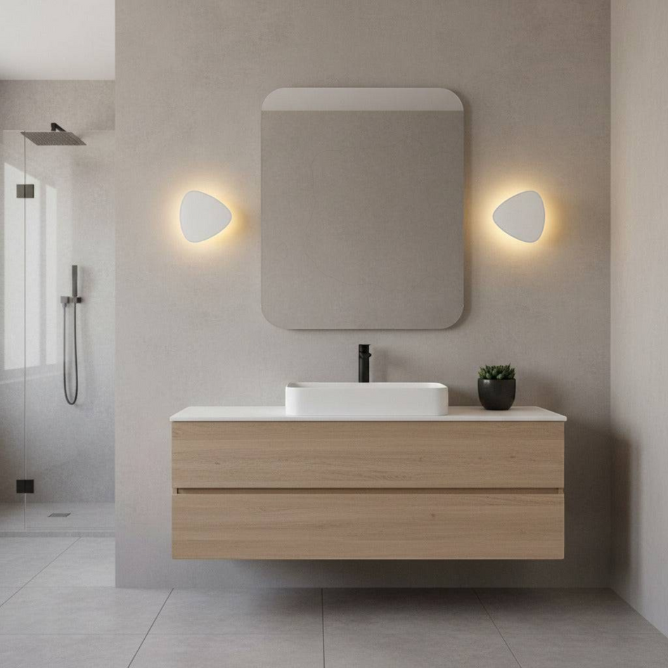 Ultra Beam Lighting Ltd triangular white LED vanity lights mounted on a modern bathroom wall with a halo effect