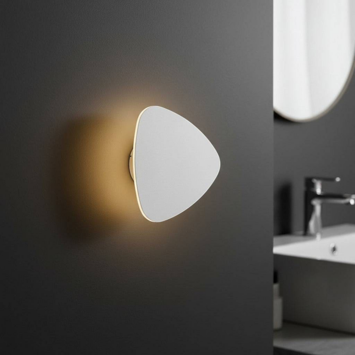 Ultra Beam Lighting Ltd triangular white LED wall light with a warm halo effect mounted on a dark bathroom wall