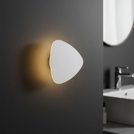 Ultra Beam Lighting Ltd triangular white LED wall light with a warm halo effect mounted on a dark bathroom wall