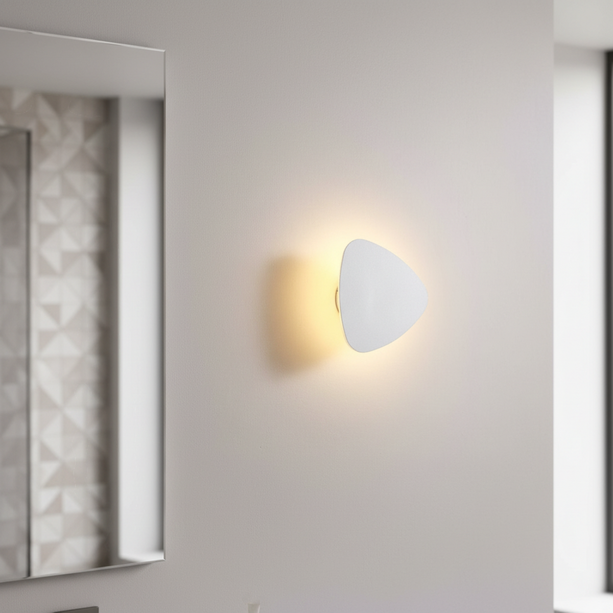 Ultra Beam Lighting Ltd triangular white LED vanity light mounted on a wall creating a warm halo effect