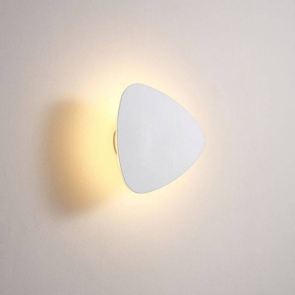 Ultra Beam Lighting Ltd triangular white LED vanity light mounted on a wall with a warm halo glow effect.