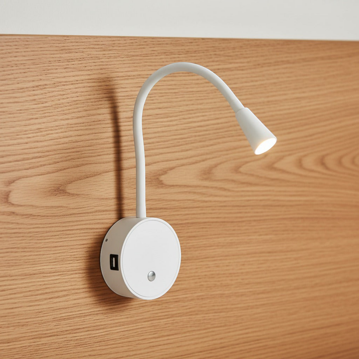 Ultra Beam Lighting Ltd white flexible LED reading lamp with integrated USB charging port mounted on wood headboard