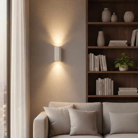 Ultra Beam Lighting Ltd white hexagonal LED wall light casting warm up and down beams on a modern living room wall.