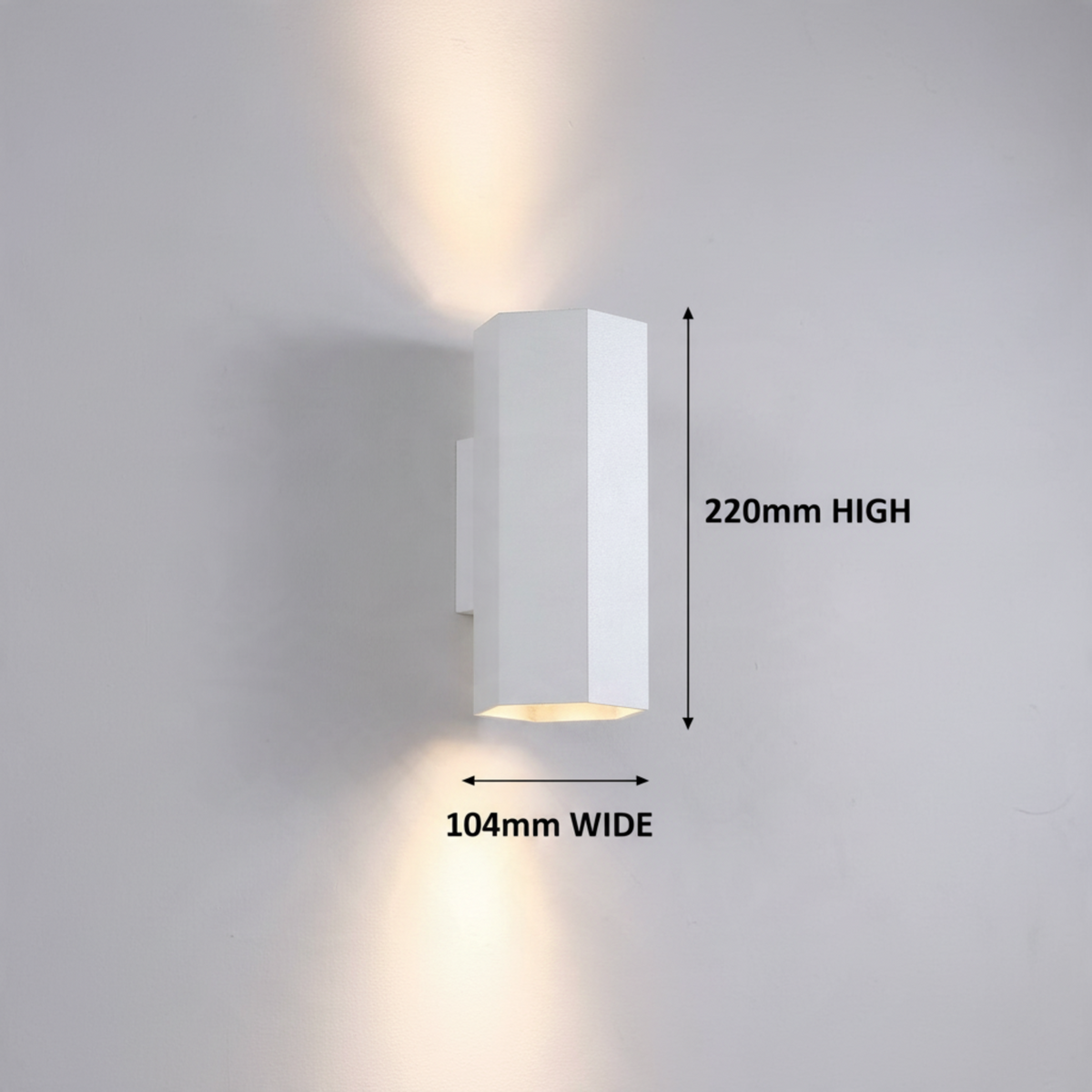 Ultra Beam Lighting Ltd white hexagonal LED wall light with dual-directional up and down illumination on a wall.