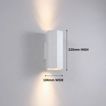 Ultra Beam Lighting Ltd white hexagonal LED wall light with dual-directional up and down illumination on a wall.