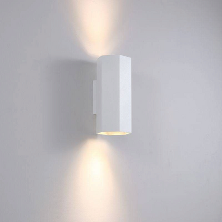 Ultra Beam Lighting Ltd white hexagonal LED wall light casting warm up and down light beams on a wall