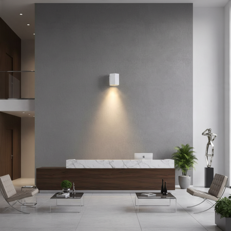 Ultra Beam Lighting Ltd white hexagonal LED wall downlight casting a warm downward beam in a modern office lobby.