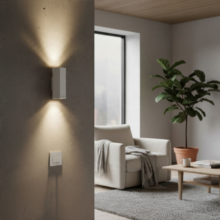 Ultra Beam Lighting Ltd white hexagonal LED wall light casting up and down beams on a modern concrete interior wall.