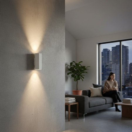 Ultra Beam Lighting Ltd white hexagonal LED wall light casting up and down beams on a modern concrete interior wall.