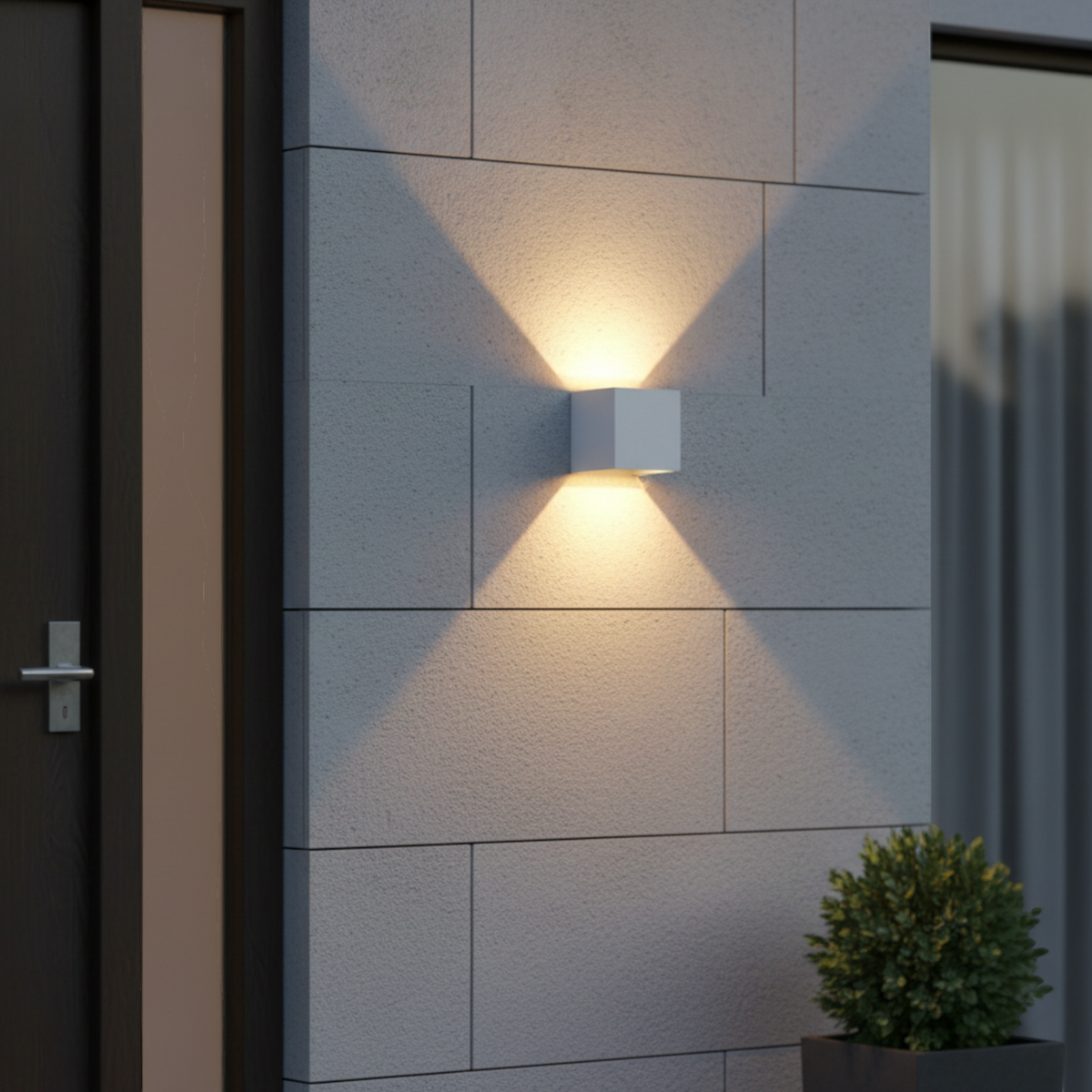 Ultra Beam Lighting Ltd white 6W LED up and down outdoor wall light casting a warm glow on a modern exterior stone wall