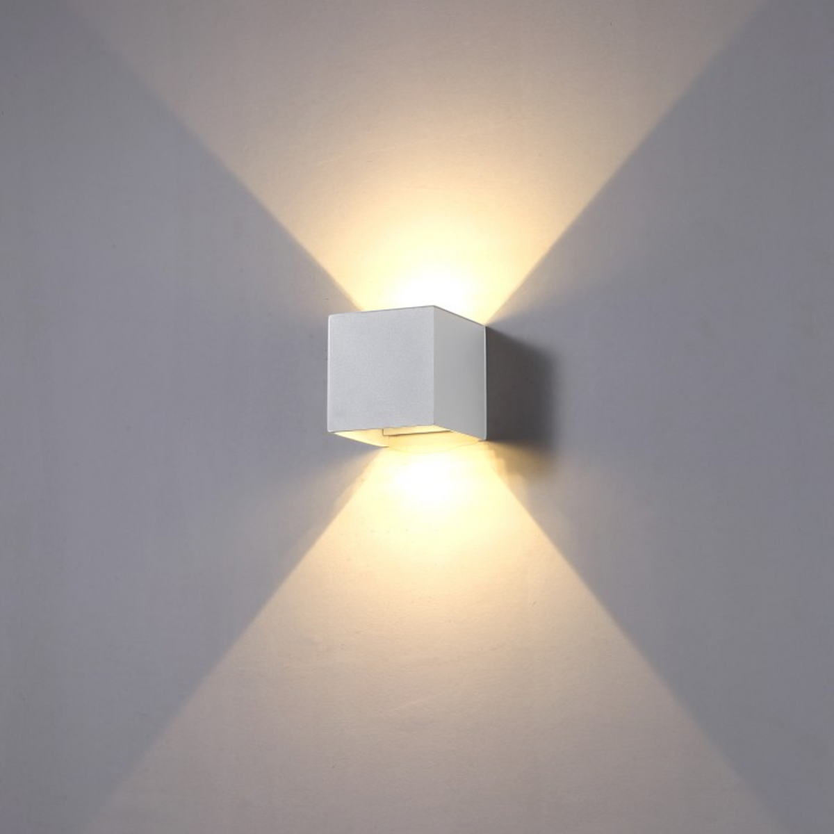 Ultra Beam Lighting Ltd white LED up and down outdoor wall light casting a warm glow on a grey wall