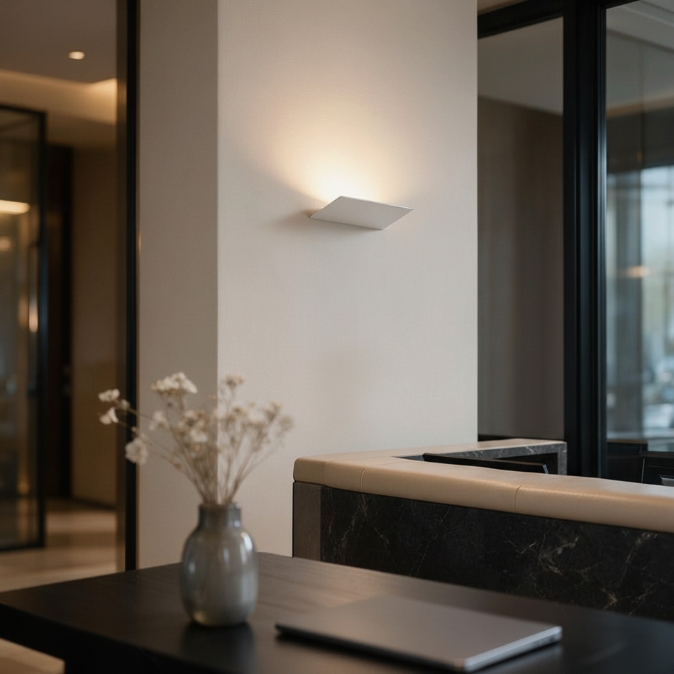 Ultra Beam Lighting Ltd 12W white LED indoor wall uplight casting a warm ambient glow on a modern interior wall.