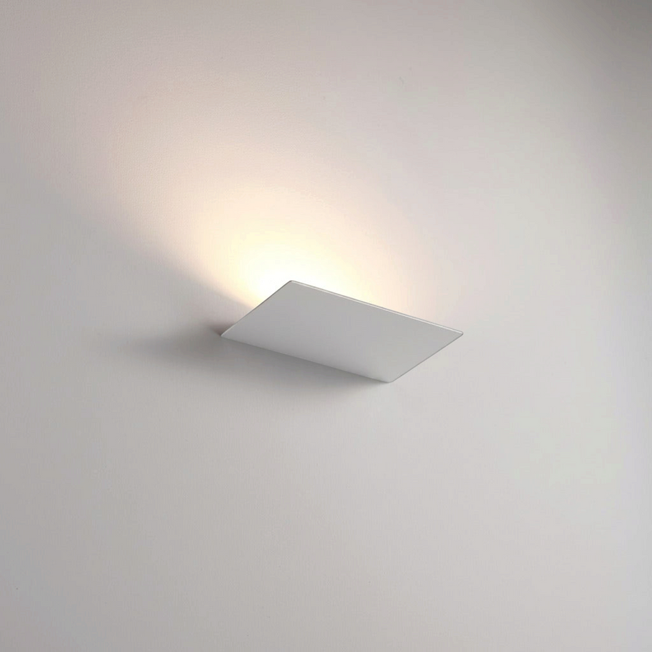 Ultra Beam Lighting Ltd 12 watt white LED indoor wall uplight casting a warm ambient glow on a plain wall