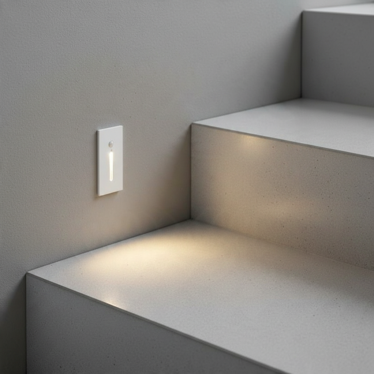 Ultra Beam Lighting Ltd white recessed LED step light with motion sensor illuminating a modern staircase