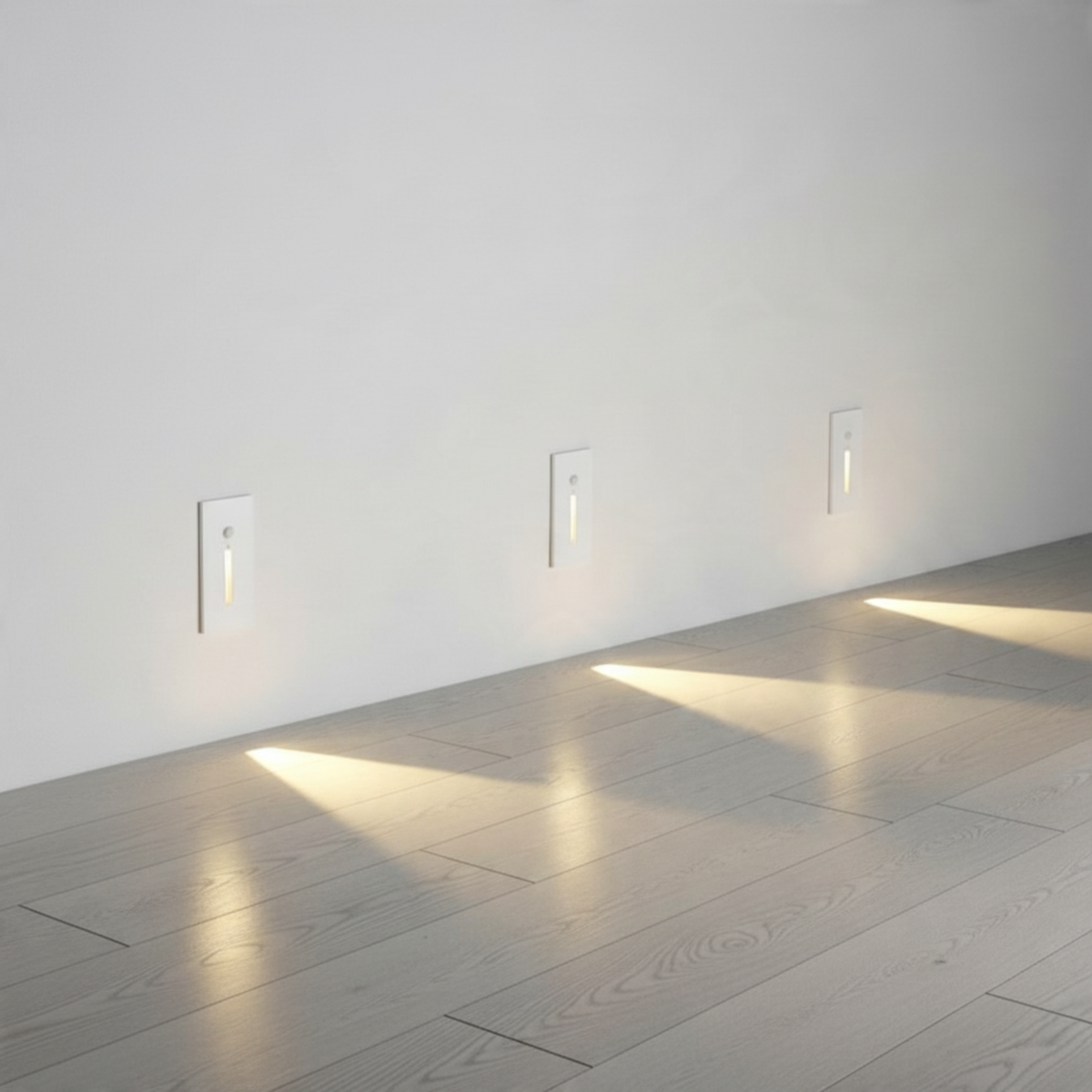 Ultra Beam Lighting Ltd white recessed LED step lights with motion sensors installed along a hallway wall
