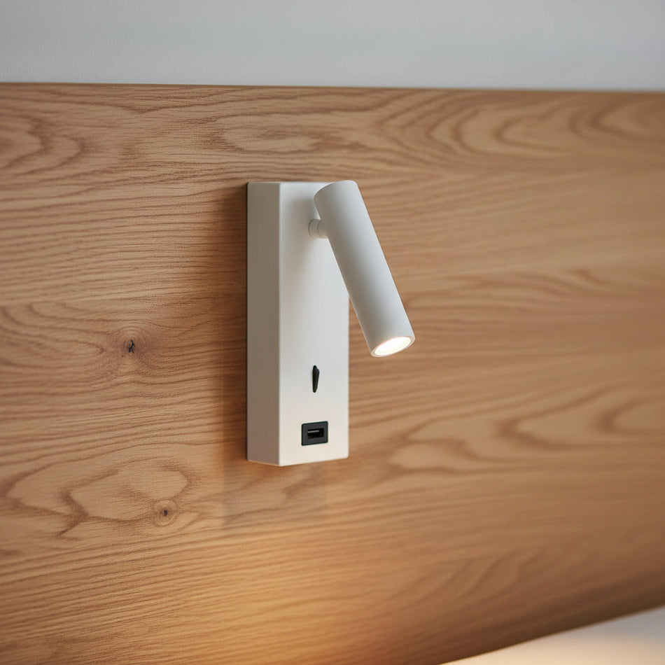 Ultra Beam Lighting Ltd white wall mounted LED reading lamp with integrated USB charging port on a wooden headboard.