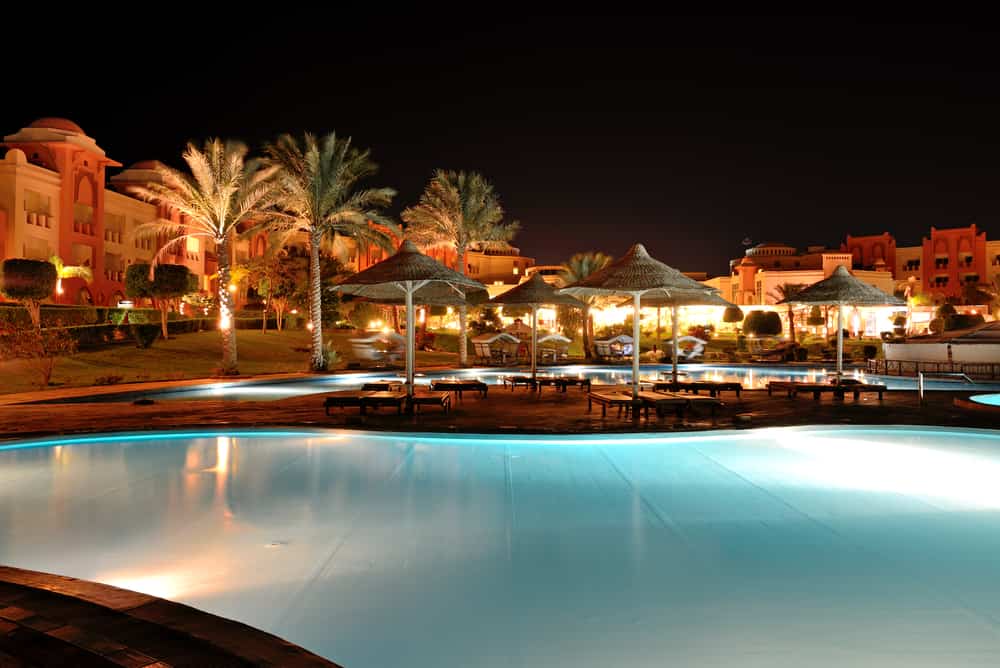 hotel swimming pool and exterior illuminated at night
