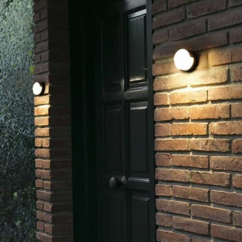 LWA383-BK black orund outdoor wall light fitted on a modern home