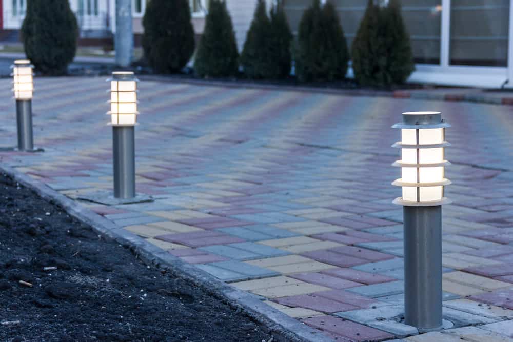 Driveway lit up with outdoor bollard lights along the side