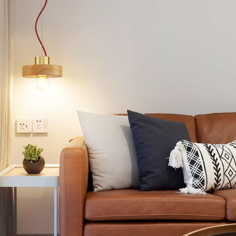 LPL350- wooden LED pendant light hung next to a sofa